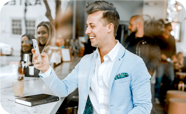 Young businessman using SMS marketing on his smartphone
